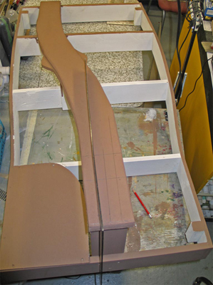 Brinker Pass West while module construction was in progress. The wide section in the roadbed is where the siding and factory building will go. The rafter square is being used to measure the correct distance for the tracks to be set back from the end of the module.