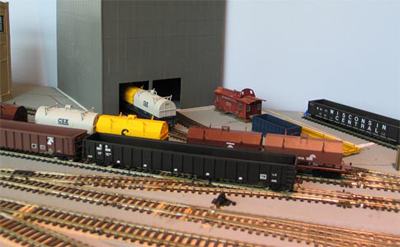 A close-up of the finishing mill.  The cars are pushed into the building for loading, but the locomotive stays outside.