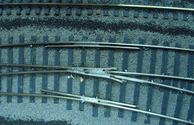 Close up of one of the switch frogs, with its associated guard rails. The guard rails ensure that the car wheels running through the frog follow the desired route.