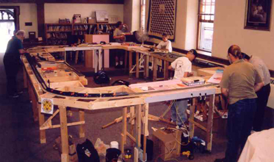 The full layout is set up.  A few minor adjustments, and the trains start running.